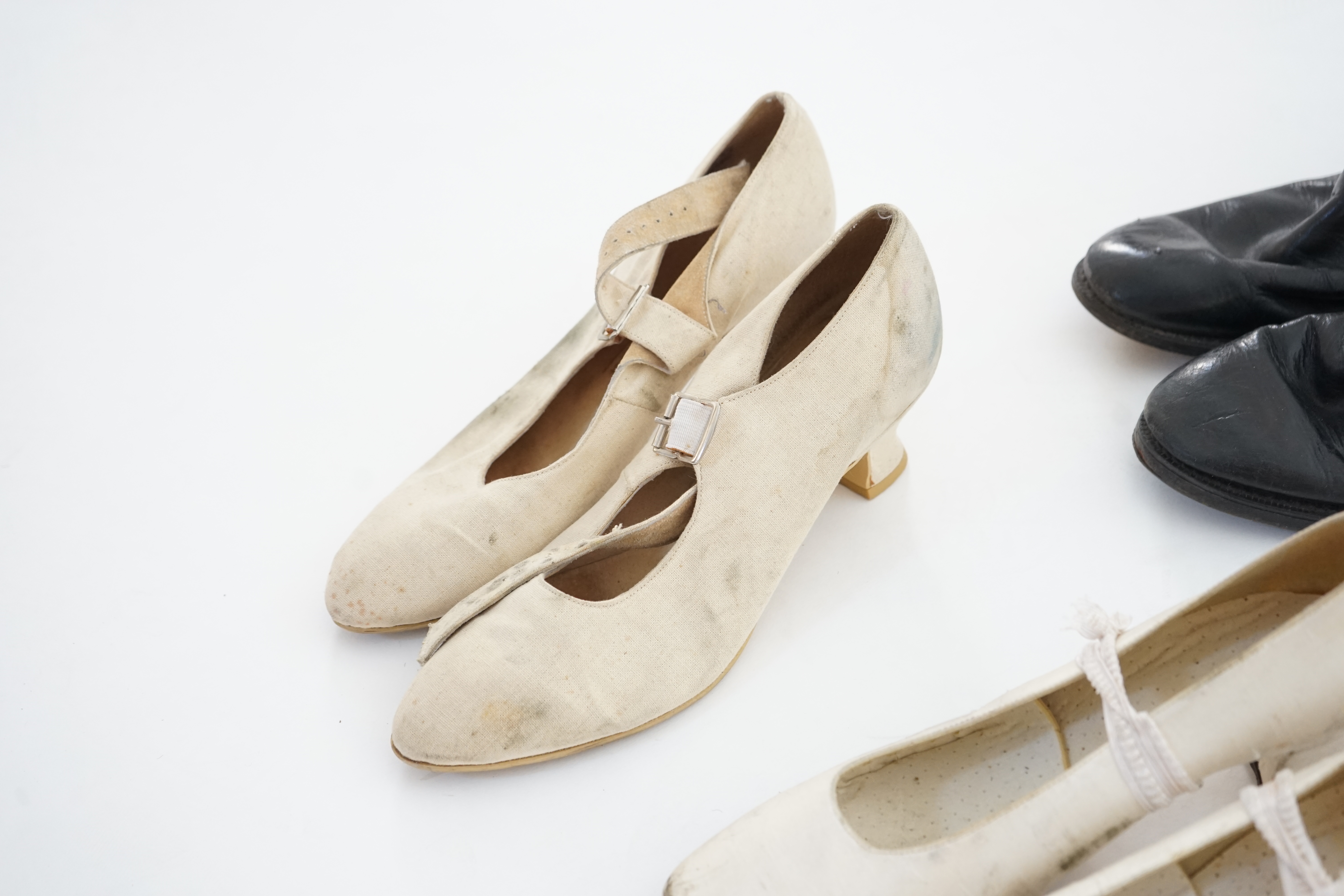 A box of assorted lady's and men's boots and shoes.